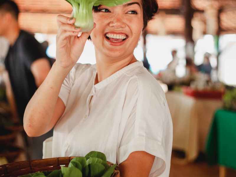 happy ethnic woman with salad leaf
